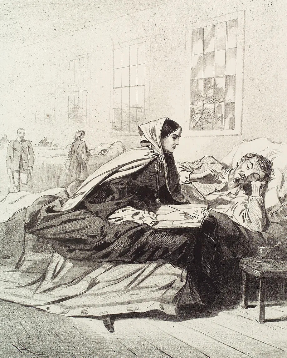 A black and white drawing of a woman wearing a bonnet, a long dress, and a cape sitting on a bed. She is writing a letter. Next to the woman is a man lying down. Behind them are several rows of beds. Another woman stands in front of one of the beds. Next to her is a man with only one leg, who holds crutches in his hands.