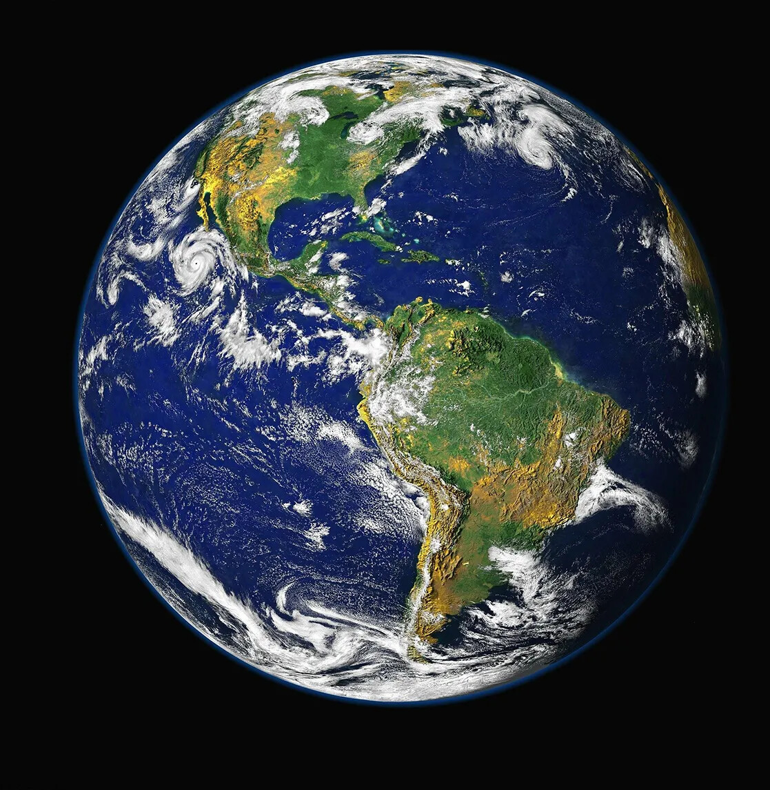 A colored photograph of the Earth, with the continents displayed in green and yellow, and the ocean in blue. Scattered across the Earth are white clouds in various versions of weather.
